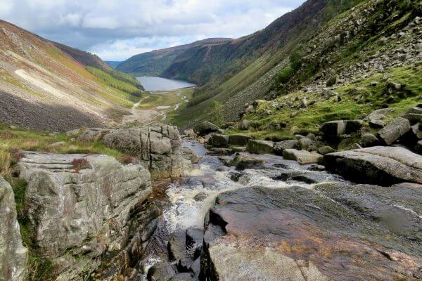 Wicklow Way: Der Glenealo River Wasserfall mit Blick zum Oberen See von Glendalough in den Wicklow Mountains